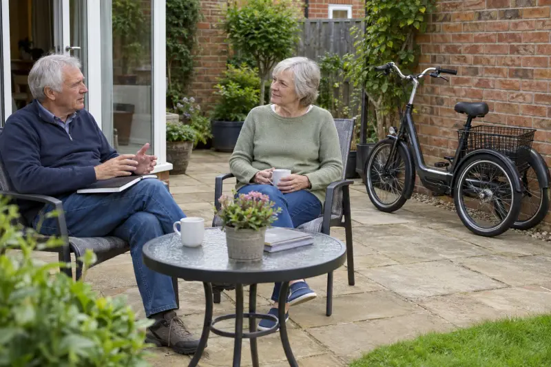 Illustrative household conversation in a private courtyard, with a closed notebook and unused generic tricycle.