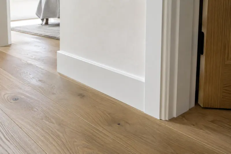 A completed floor, skirting and wall junction beside a doorway.