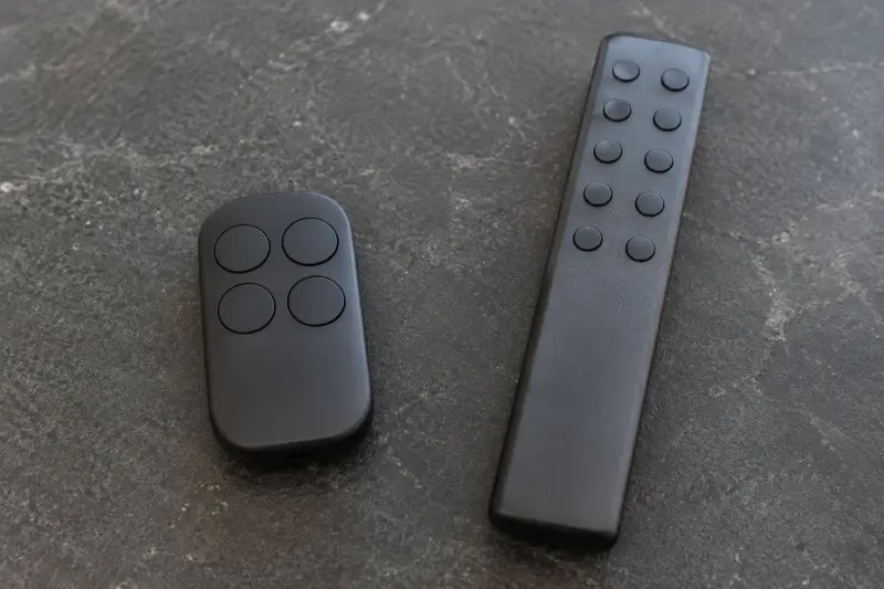 Illustrative separate plain control shapes with differently sized blank buttons.